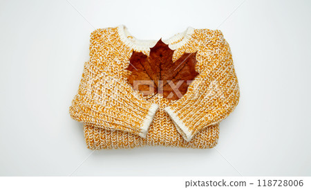 Autumn clothing. Warm golden sweater. Top view Autumn clothing. Warm golden sweater. Top view 118728006