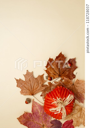 Autumn composition with maple leaves, decorative pumpkins and candles. Top view. Copy space 118728037