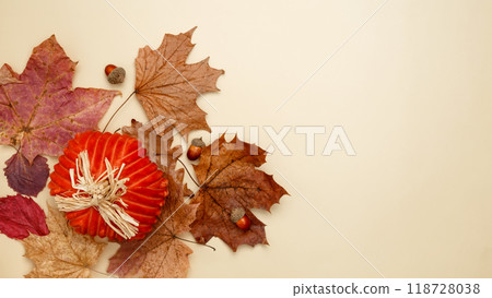 Autumn composition with maple leaves, decorative pumpkins and candles. Top view. Copy space 118728038