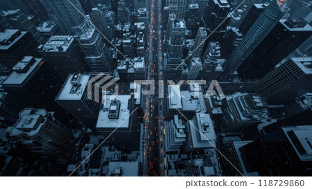 An aerial view of a city at night, with tall buildings and bright lights. 118729860