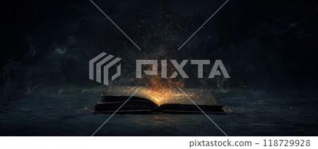 Glowing open book on a dark background, magical light. 118729928