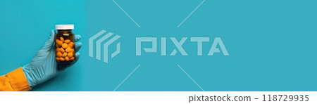 Hand in blue glove holding a smartphone on a blue background. 118729935