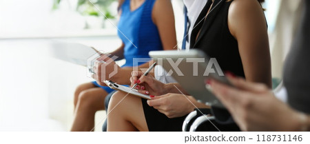 Group of people hold silver pens and pad ready to make marks while sit in row at seminar training 118731146