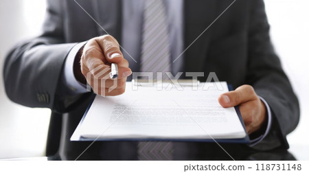 Businessman propose to sign paper, give silver pen to make deal on document 118731148