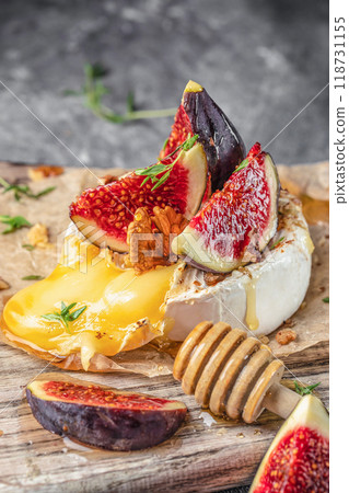 baked cheese brie with with figs, nuts and honey, Delicious balanced food concept 118731155