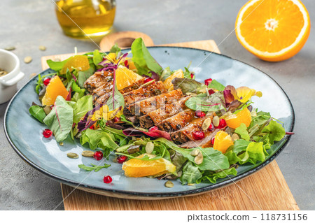 Duck salad with grilled breast and vegetables on plate, top view 118731156