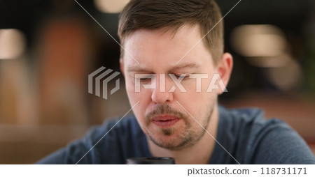 Sad and overwhelmed with something bearded middle aged person looking down 118731171