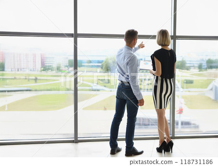 Man meet with real estate agent woman point at building for rent Man meet with real estate agent woman point at building for rent 118731186