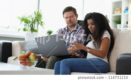 Middle aged man and latino american woman choosing something online Middle aged man and latino american woman choosing something online 118731210