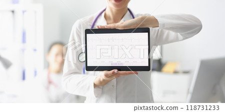 Doctor showing digital tablet screen with heart cardiogram result 118731233