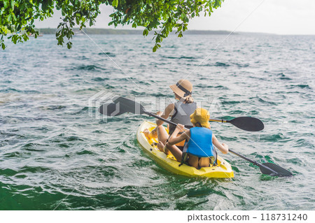Mother and son tourists kayaking on Bacalar Lake in Mexico. Adventure tourism in Quintana Roo, outdoor exploration, and water activities concept 118731240