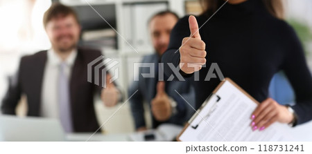Group of young businesspeople happy to make good deal show thumbs up 118731241