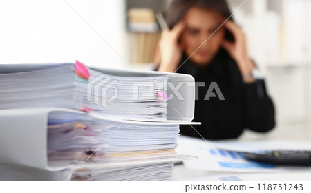 Tired and exhausted woman looks at documents touch head with hands 118731243