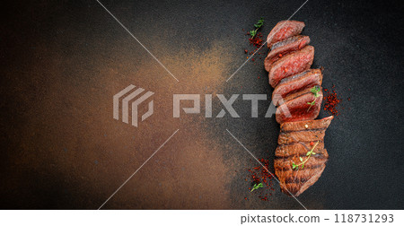 Cut rare rib eye steak on a dark background. top view. copy space for text Cut rare rib eye steak on a dark background. top view. copy space for text 118731293