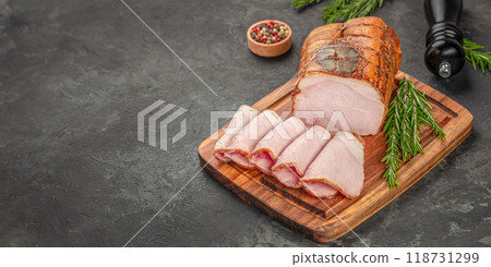 smoked ham on a wooden board. Long banner format. top view. copy space 118731299