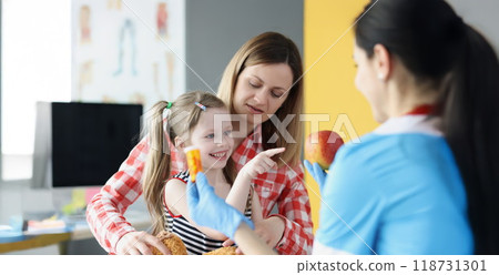 Happy little girl choose apple instead of bottle of medications 118731301