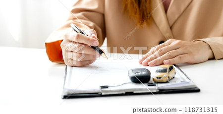 Customer hand signed the insurance contract documentation agreement for commercial auto car loan buying or vehicle rental service Customer hand signed the insurance contract documentation agreement for commercial auto car loan buying or vehicle rental service 118731315