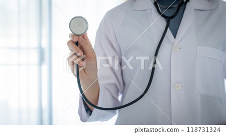 Doctor hand holding stethoscope in front of her with a white background healthcare concept 118731324