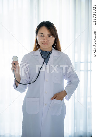 Doctor hand holding stethoscope in front of her with a white background healthcare concept 118731325
