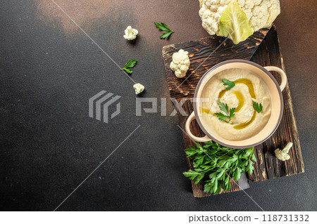 Healthy vegan cauliflower cream soup on dark background, vegan food, banner, menu, recipe place for text, top view Healthy vegan cauliflower cream soup on dark background, vegan food, banner, menu, recipe place for text, top view 118731332