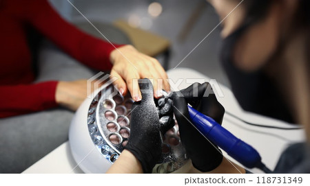 Nail master use special equipment for working with clients manicure Nail master use special equipment for working with clients manicure 118731349