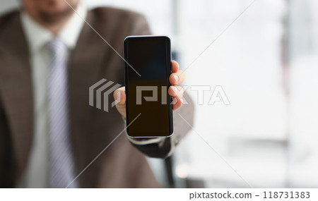 Male arm in suit show in camera mobile phone display with black screen 118731383