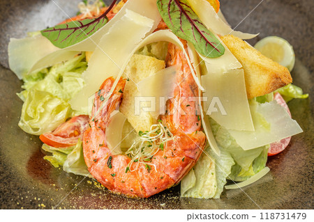 shrimp salad. Caesar salad with shrimp, lettuce, parmesan cheese. Food recipe background. Close up. top view shrimp salad. Caesar salad with shrimp, lettuce, parmesan cheese. Food recipe background. Close up. top view 118731479