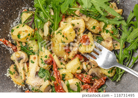 Gnocchi with mushrooms and arugula, parmesan cheese. Healthy eating. Food recipe background. Close up. top view Gnocchi with mushrooms and arugula, parmesan cheese. Healthy eating. Food recipe background. Close up. top view 118731495