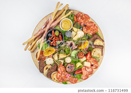antipasto. banquet cold meat plate prosciutto ham, salami, olives and grissini breadsticks, cheese. top view. copy space for text 118731499
