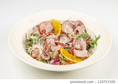 Delicious salad with slices of roast beef, salad mix, sun-dried tomatoes, grilled mushrooms dressed with cheese sauce 118731500