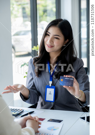 Employees present with mock up credit card payments to business customers. Ready to provide discounts and life insurance 118731506