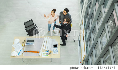 Engineer team is meeting to inspect the construction blueprint drawings, work plan and distribute work before starting the building Engineer team is meeting to inspect the construction blueprint drawings, work plan and distribute work before starting the building 118731571