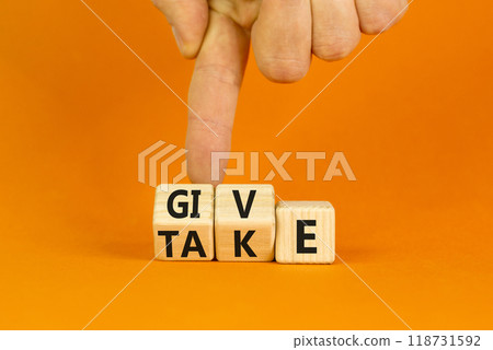 Give or take symbol. Concept word Give or Take on wooden cubes. Beautiful orange table orange background. Businessman hand. Business give or take concept. Copy space. Give or take symbol. Concept word Give or Take on wooden cubes. Beautiful orange table orange background. Businessman hand. Business give or take concept. Copy space. 118731592