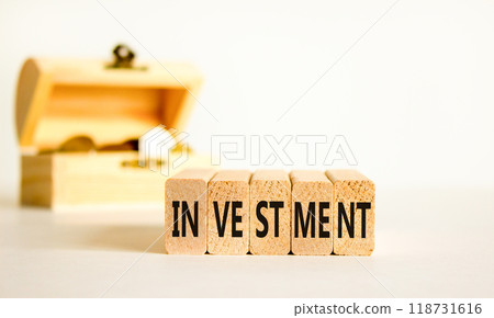 Investment symbol. Concept word Investment on beautiful wooden blocks. Beautiful white background. Beautiful wooden chest with coins. Business investment concept. Copy space. Investment symbol. Concept word Investment on beautiful wooden blocks. Beautiful white background. Beautiful wooden chest with coins. Business investment concept. Copy space. 118731616