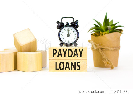 Payday loans symbol. Concept words Payday loans on beautiful wooden block. Beautiful white table white background. Black alarm clock. Business and Payday loans concept. Copy space. 118731723