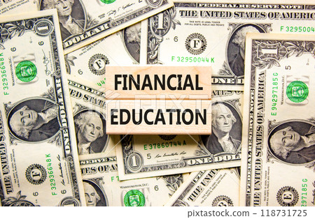 Financial education symbol. Concept words Financial education on beautiful wooden block. Beautiful dollar bills background. Dollar bills. Business Financial education concept. Copy space. 118731725
