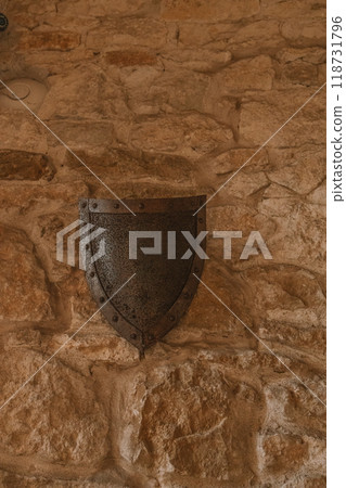 Ancient warrior shield with little shadow on the old wall in a Castle Bobolice Ancient warrior shield with little shadow on the old wall in a Castle Bobolice 118731796