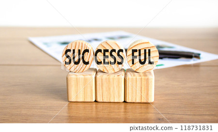 Successful symbol. Concept word Successful on beautiful wooden circles. Beautiful wooden table white background. Black pen. White document. Business successful concept. Copy space. Successful symbol. Concept word Successful on beautiful wooden circles. Beautiful wooden table white background. Black pen. White document. Business successful concept. Copy space. 118731831