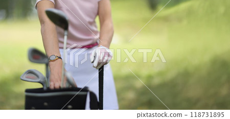 Professional female golf player choosing golf club from bag Professional female golf player choosing golf club from bag 118731895