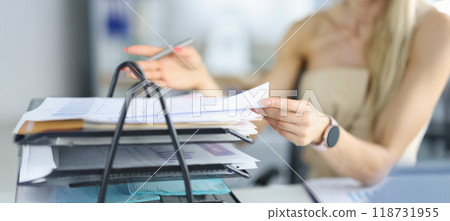 Female busy with papers on workplace, documents and problem projects, day in hurry Female busy with papers on workplace, documents and problem projects, day in hurry 118731955