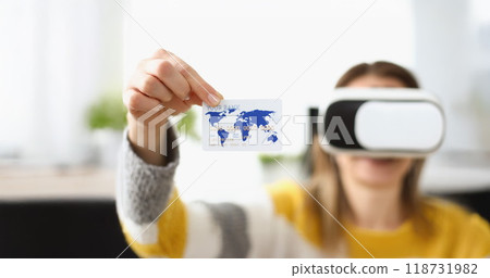 Young woman wearing virtual glasses and showing credit card Young woman wearing virtual glasses and showing credit card 118731982