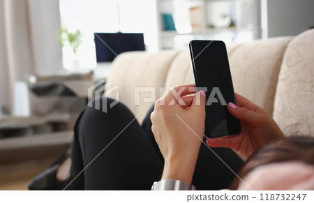Female laying on couch with smartphone turned off black screen Female laying on couch with smartphone turned off black screen 118732247