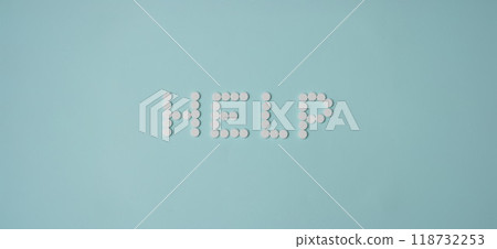 Help lettering made with white round shaped pill, drug prescription for treatment 118732253