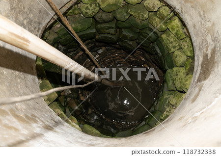 View of the village well with water. View of the village well with water. 118732338