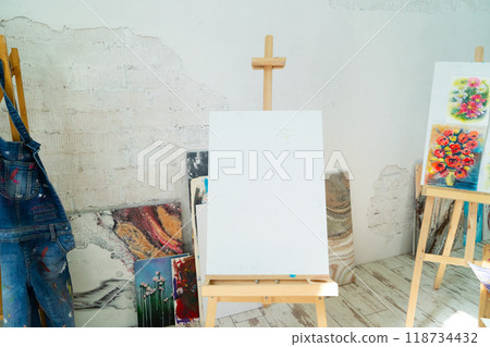 A Bright and Innovative Art Studio Featuring Beautiful Wooden Furniture along with Captivating Paintings 118734432