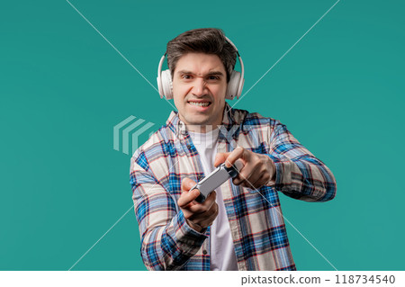 Mature 30s man playing online video game on console TV with joystick. e-sport Mature 30s man playing online video game on console TV with joystick. e-sport 118734540