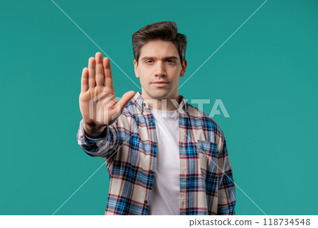 Serious adult 30s man showing rejecting gesture by stop palm sign. Dont play me 118734548