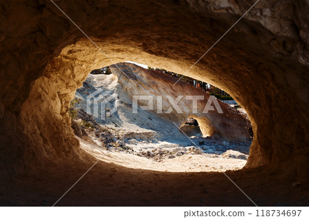 A scenic view through the natural opening of a cave 118734697