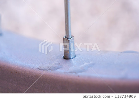 Closeup of a bicycle spoke connecting to the wheel rim. Closeup of a bicycle spoke connecting to the wheel rim. 118734909