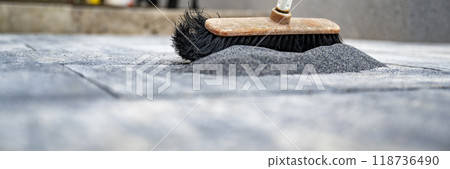 Brushing sand in cement tile gaps Brushing sand in cement tile gaps 118736490
